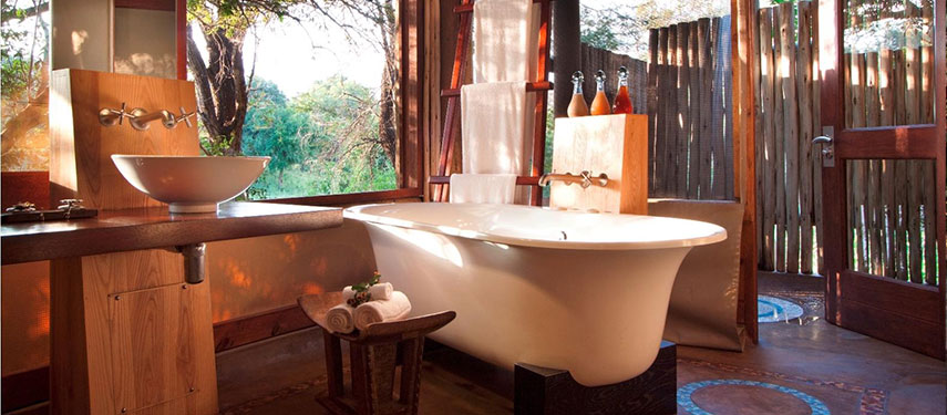 Private en suite bathroom with spectacular views and indulgent claw-foot bath at a safari lodge in South Africa