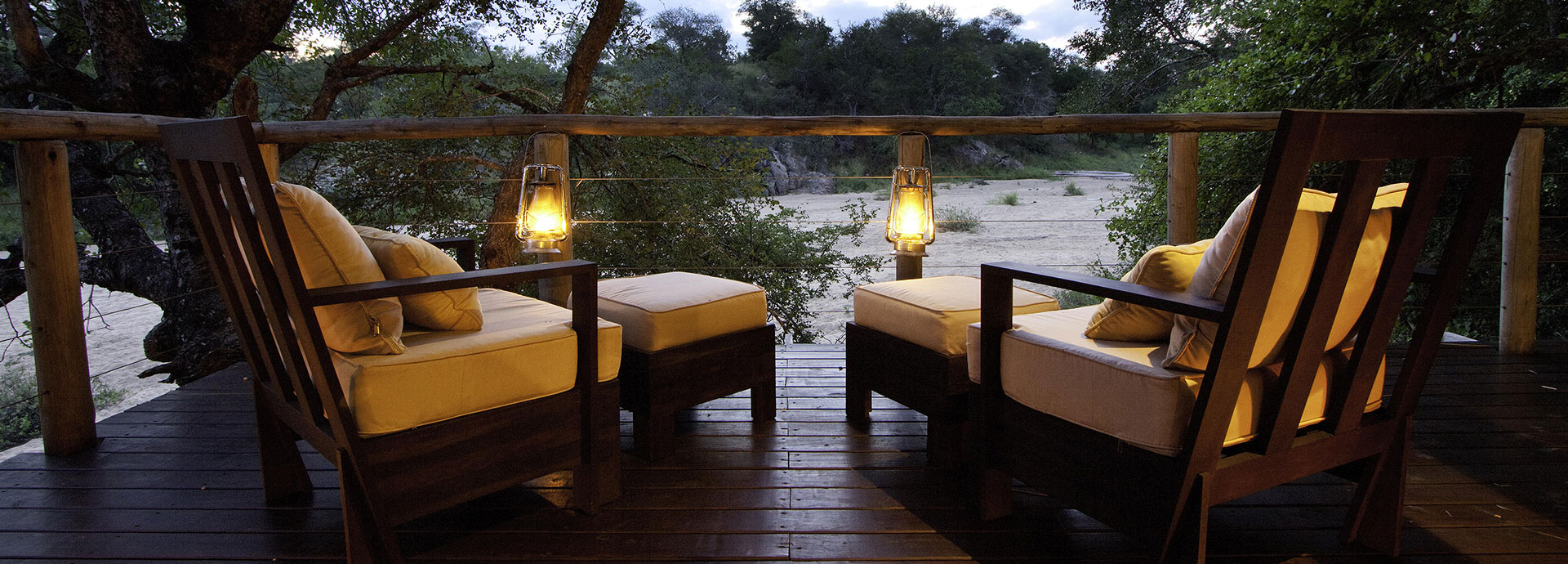Sunset view of a creek bed from the deck at Rhino Post Safari Lodge in Kruger National Park
