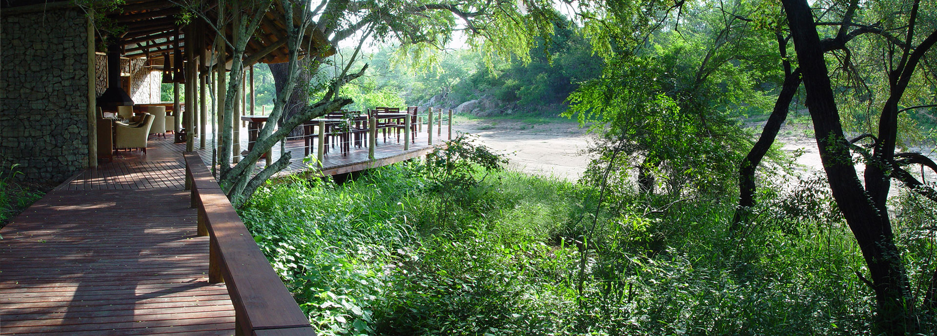 View of a dry creek bed from the deck at Rhino Post Safari Lodge in Kruger National Park