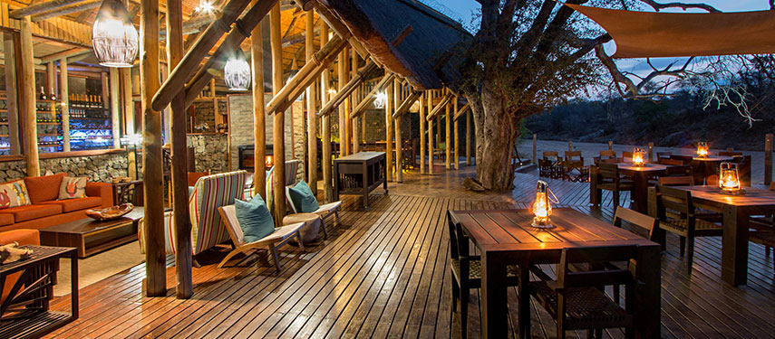 The cosy dining deck at sundown at Rhino Post Safari Lodge in Kruger National Park, South Africa