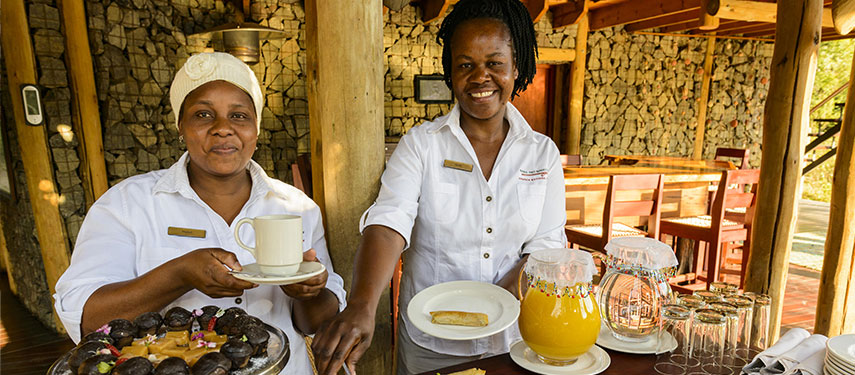 Staff serving coffee and breakfast at Rhino Post Safari Lodge in Kruger National Park, South Africa