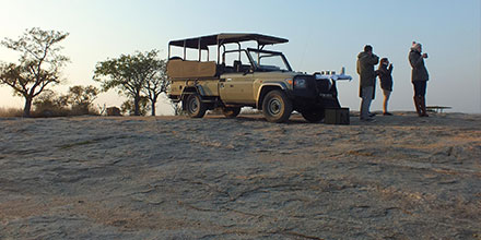 Group enjoys sundowners on a private game drive in Kruger National Park