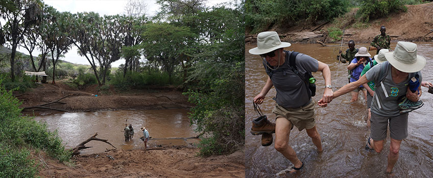 Safari hikers cross a river in Africa