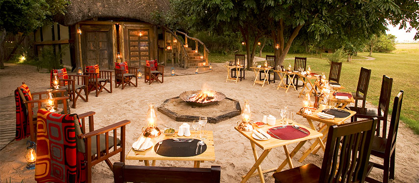 Sit around the campfire and share safari stores at Selinda Camp