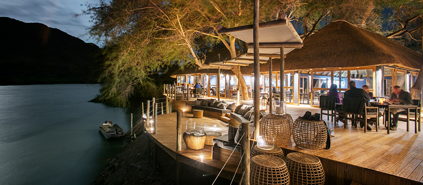 Serra Cafema Safari lodge with wide balcony overlooking the Kunene River at sunset