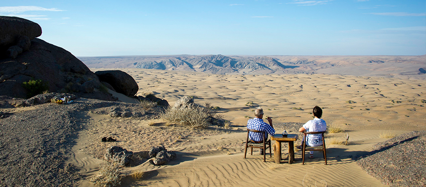 Guests view the otherworldly landscapes of Kaokoveld, Namibia from Serra Cafema Camp