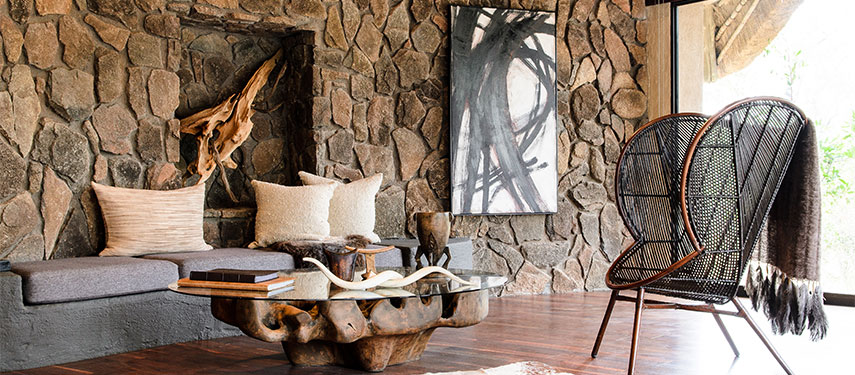 The elegant suites at Singita Boulders Lodge include spacious interiors a fireplace, private deck, outdoor shower and private pool.