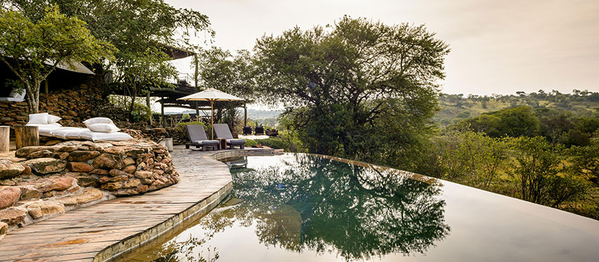 Relax by the pool and enjoy views of the Grumeti wilderness at Singita Faru Faru