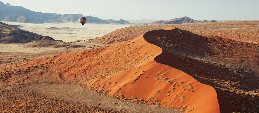 Hot-air balloons over the Namibian desert at sunrise