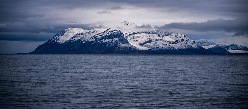 The wintery mountains of Svalbard viewed across the Arctic sea