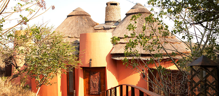 Exterior view of thatched rooms at Thanda Safari Lodge