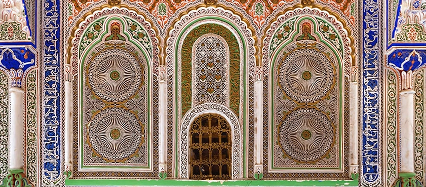 Close-up of elaborate carved plaster and colourful tilework at the Zawiya of Moulay Idriss II in Fès.