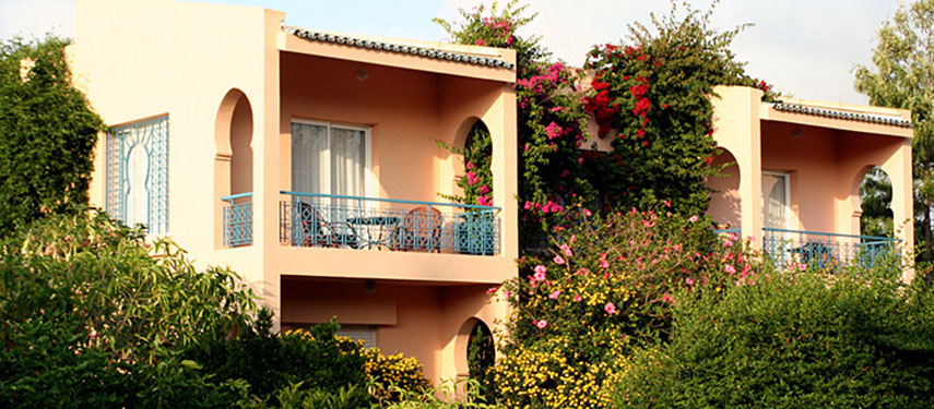 Peer out over the cultivated rose garden from the balcony of your room at Villa Mandarine