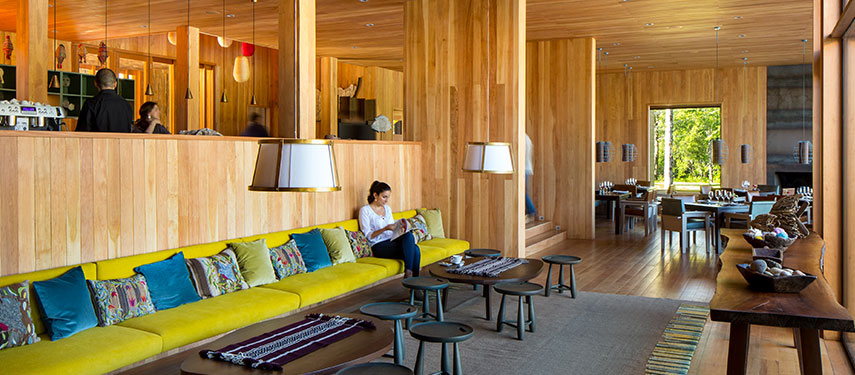 Woman reading in the bar area of Hotel Vira Vira in Patagonia, Chile
