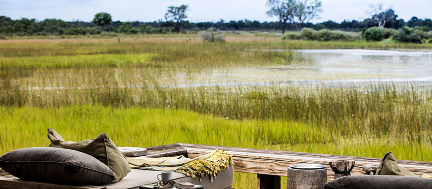 A view over grassy plains from Vumbura Plains safari lodge in Botswana's Okavango Delta