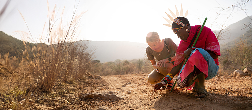 Maasai guide Philip Leresh and guest tracking wildlife on foot in the Samburu wilderness.