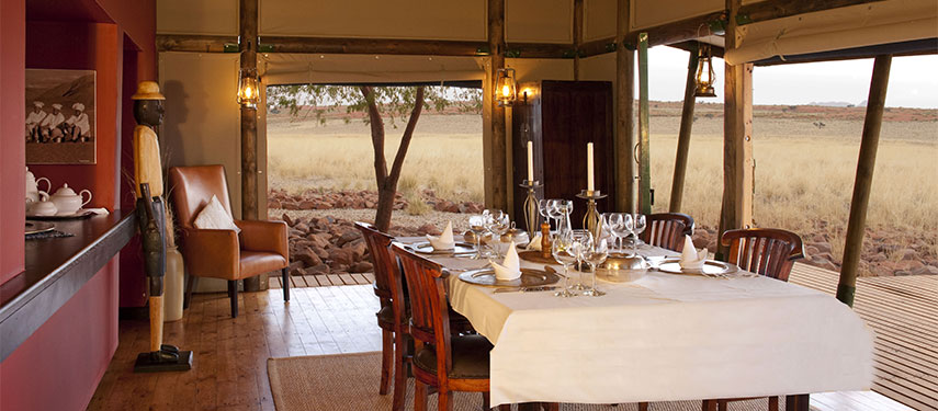 Dine in style with views of the Namib Rand Desert at Wolwedans Private Camp in Namibia